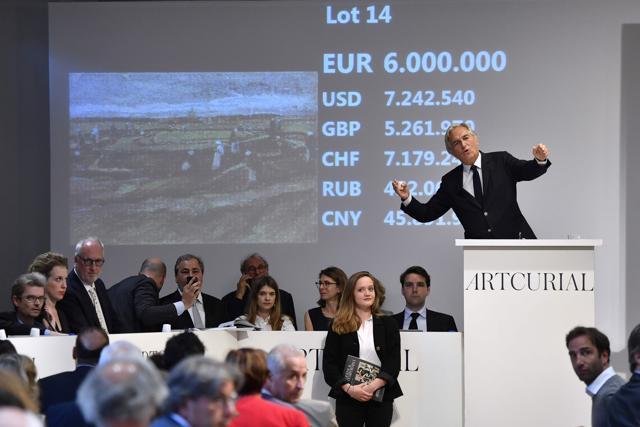 Auctioneer Francis Briest (R) announces the sale during the auctioning of the 1882 painting by Dutch artist Vincent Van Gogh "Women Mending Nets in the Dunes" at the Artcurial auction house in Paris. (AFP) Auctioneer Francis Briest (R) announces the sale during the auctioning of the 1882 painting by Dutch artist Vincent Van Gogh "Women Mending Nets in the Dunes" at the Artcurial auction house in Paris. (AFP)