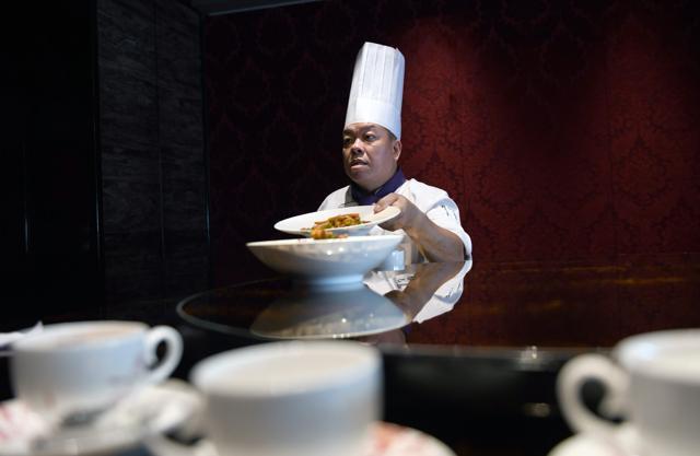 Chan started his career by wheeling a restaurant dim sum trolley to support his family. (AFP) Chan started his career by wheeling a restaurant dim sum trolley to support his family. (AFP)
