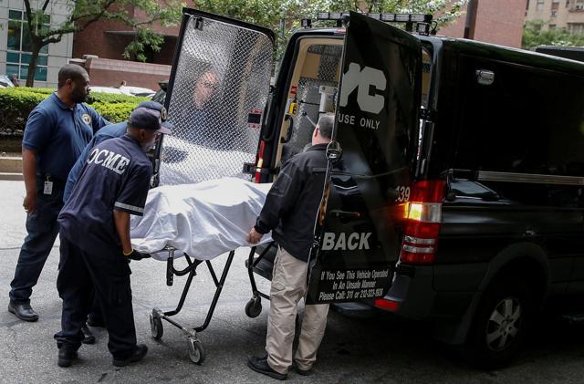 Medical examiners remove the body from the Park Avenue apartment of designer Kate Spade in New York. (REUTERS) Medical examiners remove the body from the Park Avenue apartment of designer Kate Spade in New York. (REUTERS)