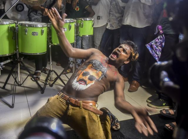 Fans of Rajinikanth displays body paint with a portrait of the actor&nbsp;as others dance on the first day of release of his new film Kaala at Carnival Cinemas IMAX Wadala in Mumbai on Thursday, June 7, 2018. (Kunal Patil/HT Photo)