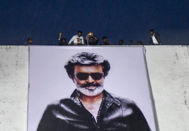 Fans pours water on a hoarding of Rajinikanth, erected in front of a movie theatre&nbsp;on the first day of release of Kaala at Carnival Cinemas IMAX Wadala in Mumbai, on Thursday.&nbsp; (Kunal Patil/HT Photo)