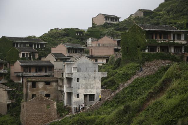 Visitors must take a boat to Shengshan then a taxi up a hill to a cemetery overlooking the village, and then descend down perilous footpaths into the mist and ivy. (AP) Visitors must take a boat to Shengshan then a taxi up a hill to a cemetery overlooking the village, and then descend down perilous footpaths into the mist and ivy. (AP)