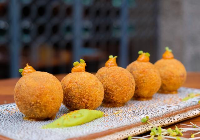 The Asian arancini, a take on the Sicilian deep-fried cheese-and-risotto balls, aren’t Asian in the least, but are a crunchy, flavourful delight.