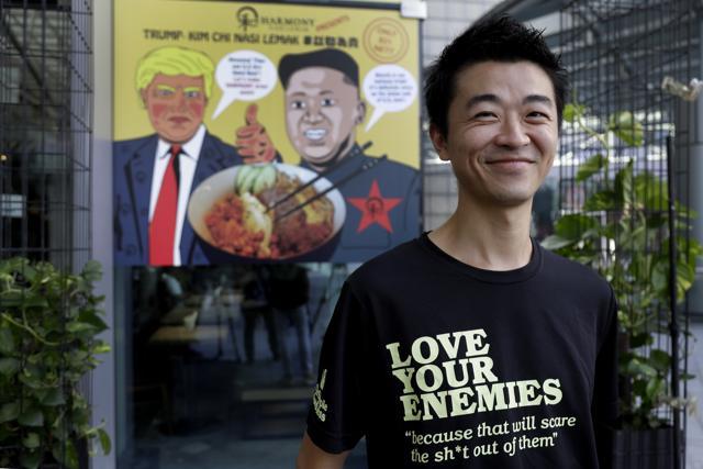 Zach Wen, 34, co-founder of Harmony Nasi Lemak poses in front of an advertisement board of cartoon caricatures of US President Donald Trump and North Korean leader Kim Jong Un which are supposed to be the inspiration behind a local dish, the "Trump-Kim Chi Nasi Lemak," in Singapore. (AP Photo) Zach Wen, 34, co-founder of Harmony Nasi Lemak poses in front of an advertisement board of cartoon caricatures of US President Donald Trump and North Korean leader Kim Jong Un which are supposed to be the inspiration behind a local dish, the "Trump-Kim Chi Nasi Lemak," in Singapore. (AP Photo)