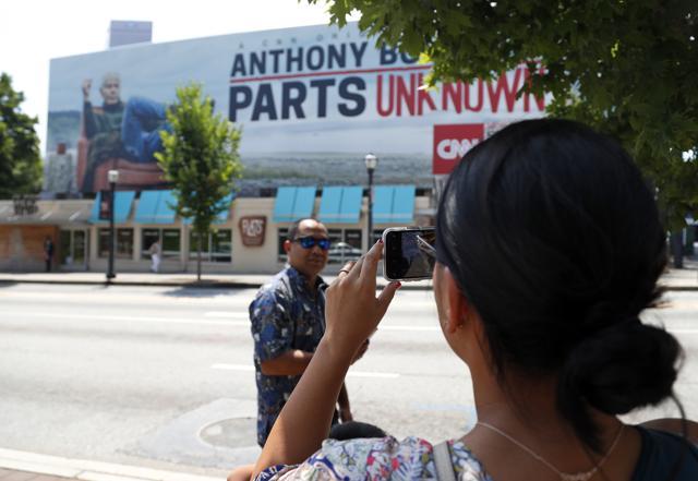 A woman takes a photograph of a billboard for the CNN television show "Parts Unknown" with American celebrity chef Anthony Bourdain, in Atlanta on June 8. (AP Photo) A woman takes a photograph of a billboard for the CNN television show "Parts Unknown" with American celebrity chef Anthony Bourdain, in Atlanta on June 8. (AP Photo)