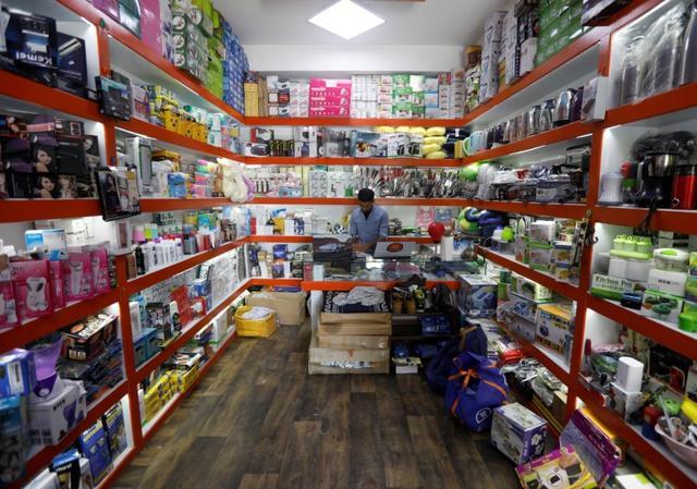 A shopkeeper works on his laptop at his online shop in Kabul, Afghanistan. (REUTERS)
