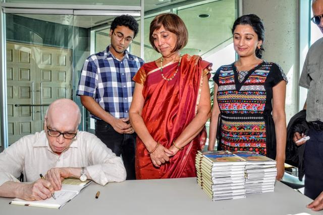 Chandrasekhar Sankurathri signing a copy of his memoir, A Ray of Hope, at its release function in Ottawa on Saturday. (Courtesy: MSMF)