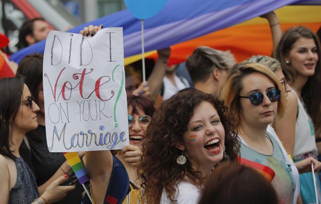 Participants, one holding a banner that reads "Did I vote on your marriage?" react, during a gay pride parade in Bucharest, Romania on June 9. (AP) Participants, one holding a banner that reads "Did I vote on your marriage?" react, during a gay pride parade in Bucharest, Romania on June 9. (AP)