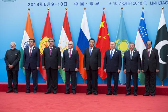 From left: Indian Prime Minister Narendra Modi, Kyrgyz President Sooronbay Jeenbekov, Tajikistan President Imomali Rakhmon, Russian President Vladimir Putin, Chinese President Xi Jinping, Kazakh President Nursultan Nazarbayev, Uzbekistan's President Shavkat Mirziyoyev and Pakistani President Mamnoon Hussain pose for a photo prior to their talks at the Shanghai Cooperation Organization (SCO) Summit in Qingdao in eastern China's Shandong Province Sunday, June 10, 2018. (AP Photo/Alexander Zemlianichenko) (AP Photo) From left: Indian Prime Minister Narendra Modi, Kyrgyz President Sooronbay Jeenbekov, Tajikistan President Imomali Rakhmon, Russian President Vladimir Putin, Chinese President Xi Jinping, Kazakh President Nursultan Nazarbayev, Uzbekistan's President Shavkat Mirziyoyev and Pakistani President Mamnoon Hussain pose for a photo prior to their talks at the Shanghai Cooperation Organization (SCO) Summit in Qingdao in eastern China's Shandong Province Sunday, June 10, 2018. (AP Photo/Alexander Zemlianichenko) (AP Photo)