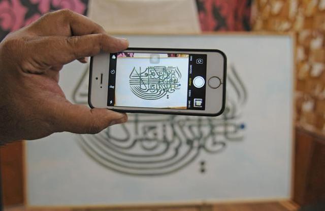 A man clicks picture during the exhibition of rare Islamic art work. (Waseem Andrabi/ HT ) A man clicks picture during the exhibition of rare Islamic art work. (Waseem Andrabi/ HT )