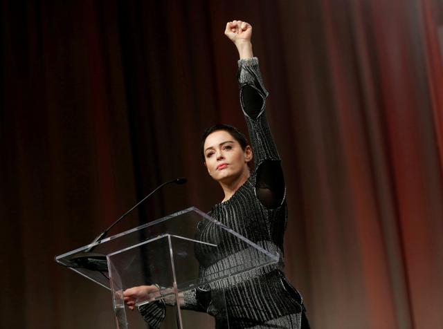 Actor Rose McGowan raises her fist after addressing the audience during the opening session of the three-day Women's Convention at Cobo Center in Detroit, Michigan. (REUTERS) Actor Rose McGowan raises her fist after addressing the audience during the opening session of the three-day Women's Convention at Cobo Center in Detroit, Michigan. (REUTERS)