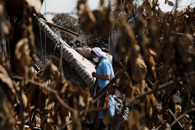 A nun prays while touring an area affected by the eruption of the Fuego volcano at San Miguel Los Lotes in Escuintla, Guatemala. (REUTERS) A nun prays while touring an area affected by the eruption of the Fuego volcano at San Miguel Los Lotes in Escuintla, Guatemala. (REUTERS)