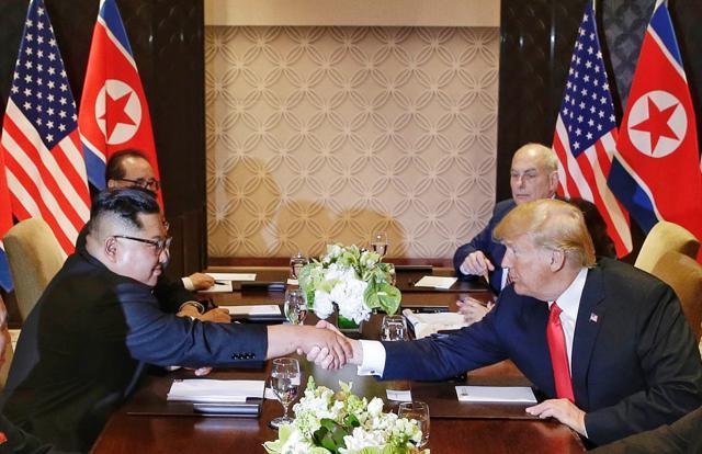 Trump and Kim shake hands during their meeting at the Capella resort on Sentosa Island Tuesday, June 12, 2018, in Singapore. (AP)