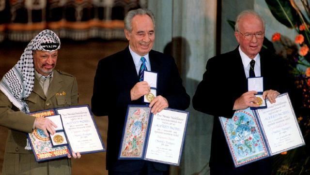 In this December 10, 1994 file photo, PLO chairman Yasser Arafat, Israeli foreign minister Shimon Peres and Israeli prime minister Yitzhak Rabin show their shared Nobel Peace Prize awards to audience in the Oslo City Hall. (Reuters )