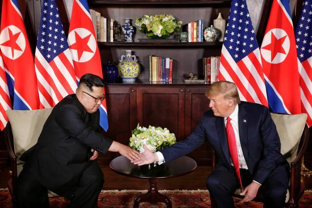 US President Donald Trump shakes hands with North Korean leader Kim Jong Un at the Capella Hotel on Sentosa island in Singapore. (The Straits Times via Reuters Photo) US President Donald Trump shakes hands with North Korean leader Kim Jong Un at the Capella Hotel on Sentosa island in Singapore. (The Straits Times via Reuters Photo)