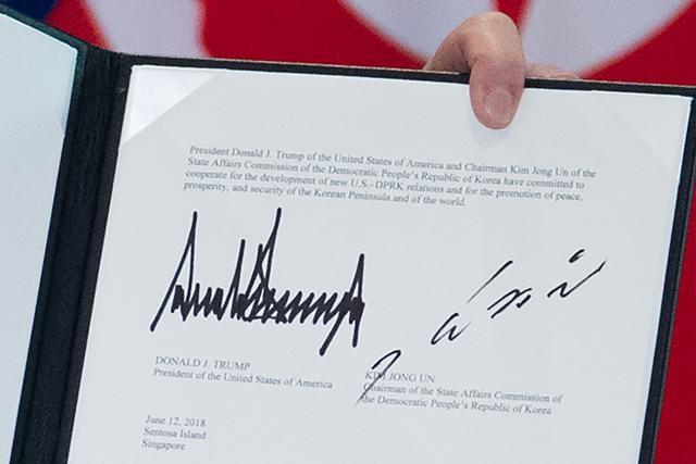 The signatures of US President Donald Trump (L) and North Korea's leader Kim Jong Un (R) are seen on a document held up by Trump following a signing ceremony during their historic US-North Korea summit, at the Capella Hotel on Sentosa island in Singapore on June 12. (AFP Photo) The signatures of US President Donald Trump (L) and North Korea's leader Kim Jong Un (R) are seen on a document held up by Trump following a signing ceremony during their historic US-North Korea summit, at the Capella Hotel on Sentosa island in Singapore on June 12. (AFP Photo)