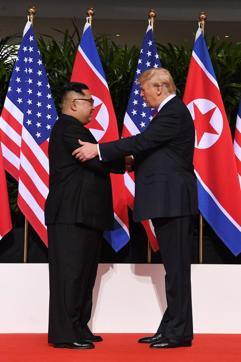 North Korea's Kim Jong Un shakes hands with US President Donald Trump at the summit. (AFP)