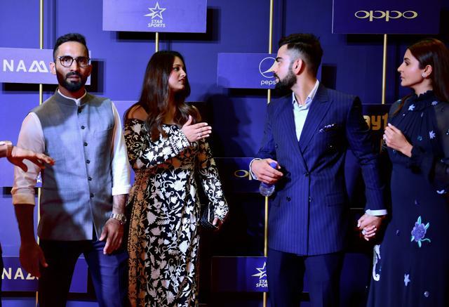 Dinesh Karthik looks on as his wife and Indian professional squash player Dipika Pallikal talks to Indian cricket captain Virat Kohli and wife and actor Anushka Sharma during the BCCI annual awards, in Bengaluru. (PTI)