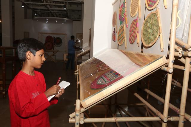 Vihaan — Nandita Das’ son — sketches a hand fan on display at the exhibition. (PHOTO: Prabhas Roy/HT)