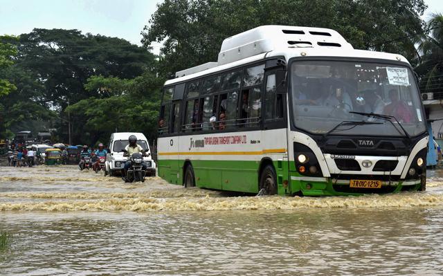 Vehicles ply on the submerged National Highway 8 following heavy rains, in Chandrapur, Tripura. (PTI) Vehicles ply on the submerged National Highway 8 following heavy rains, in Chandrapur, Tripura. (PTI)
