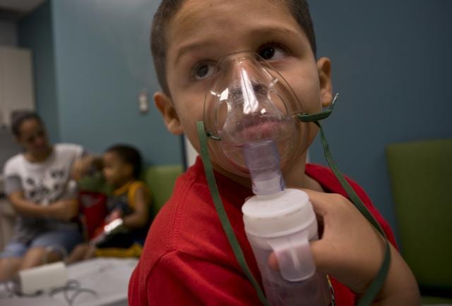 Yahir Garcia receives one of his two daily treatments for asthma at a medical centre in San Juan, Puerto Rico. (AP) Yahir Garcia receives one of his two daily treatments for asthma at a medical centre in San Juan, Puerto Rico. (AP)