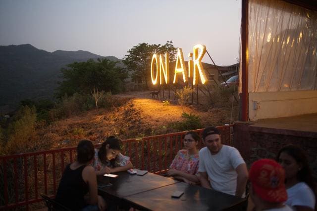 Visitors sit at On Air restaurant at dusk in Lavasa on May 12, 2018. (Bloomberg) Visitors sit at On Air restaurant at dusk in Lavasa on May 12, 2018. (Bloomberg)