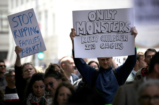 Protesters hold signs during a demonstration outside of the San Francisco office of the Immigration and Customs Enforcement (ICE) on June 19 in San Francisco, California. (AFP Photo) Protesters hold signs during a demonstration outside of the San Francisco office of the Immigration and Customs Enforcement (ICE) on June 19 in San Francisco, California. (AFP Photo)