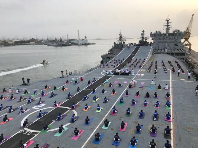 Navy personnel perform yoga on board Indian Navy’s aircraft carrier INS Virat. (Bhushan Koyande/HT Photo)