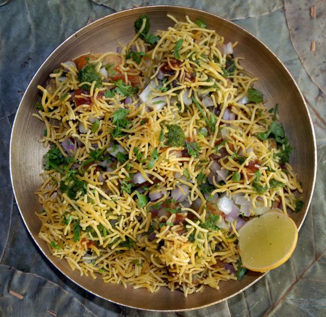 Bhel laid out neatly on six puris, transforms into Sev Puri or Lala Puri (without the puffed rice) or Pani Puri (with hollow puris stuffed with sprouts, potato, chilled jeera water) or Dahi Batata Puri, with curd added to mix. Bhel laid out neatly on six puris, transforms into Sev Puri or Lala Puri (without the puffed rice) or Pani Puri (with hollow puris stuffed with sprouts, potato, chilled jeera water) or Dahi Batata Puri, with curd added to mix.