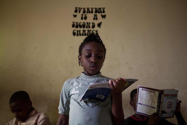 A girl of the Dream Catchers dance group reads in her home in Ikorudu, a poor suburb on the outskirts of Lagos. (AFP) A girl of the Dream Catchers dance group reads in her home in Ikorudu, a poor suburb on the outskirts of Lagos. (AFP)