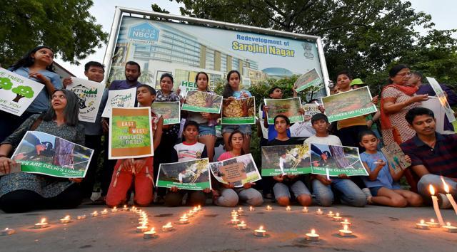 Activists from various environmental organisations during a candle light vigil against cutting of trees in Nauroji Nagar area, in New Delhi on Sunday. (PTI) Activists from various environmental organisations during a candle light vigil against cutting of trees in Nauroji Nagar area, in New Delhi on Sunday. (PTI)