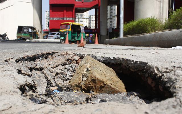 Following pre-monsoon showers road are seen caved in, near Belverde Towers Rapid metro station, in Gurugram. (Yogendra Kumar/HT PHOTO) Following pre-monsoon showers road are seen caved in, near Belverde Towers Rapid metro station, in Gurugram. (Yogendra Kumar/HT PHOTO)