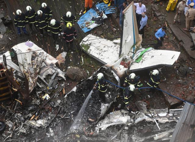 Mumbai firefighters work at the site of the chartered plane that crashed at Ghatkopar's Jivdaya Lane, in Mumbai. (PTI Photo) Mumbai firefighters work at the site of the chartered plane that crashed at Ghatkopar's Jivdaya Lane, in Mumbai. (PTI Photo)