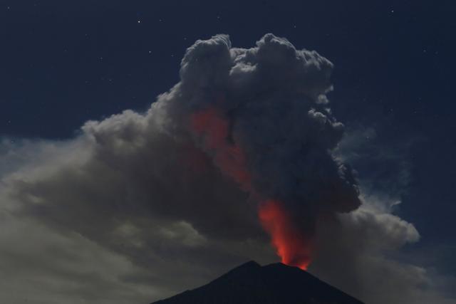 Mount Agung volcano erupts during the night, as seen from Datah village, Karangasem Regency in Bali, Indonesia on Friday. (REUTERS)