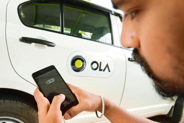 A man booking a ride on Ola. A man booking a ride on Ola.