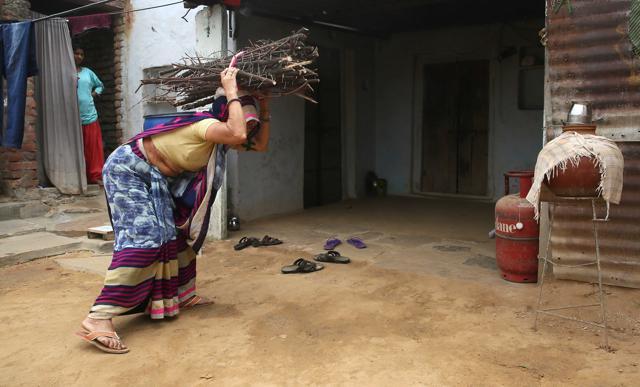 Despite having an LPG connection , Rampyari Devi brings firewood from nearby fields for cooking, as she cannot afford regular refills. (Himanshu Vyas/HT Photo) Despite having an LPG connection , Rampyari Devi brings firewood from nearby fields for cooking, as she cannot afford regular refills. (Himanshu Vyas/HT Photo)