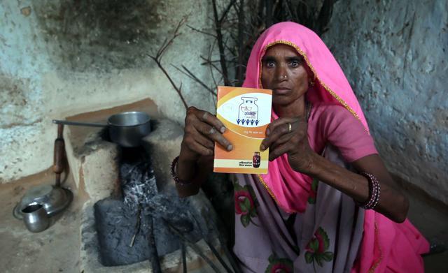 Gayatri Devi, in Bawdi village , Tonk, shows her Ujjwala Yojana consumer diary, which shows she got the connection in 2016 but could afford only two refills in 26 months. (Himanshu Vyas/HT Photo) Gayatri Devi, in Bawdi village , Tonk, shows her Ujjwala Yojana consumer diary, which shows she got the connection in 2016 but could afford only two refills in 26 months. (Himanshu Vyas/HT Photo)
