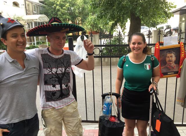 A local resident (C), who rents replicas of Joseph Stalin uniforms outside of the Stalin bunker in Samara is flanked by Mexican fans. Stalin's secret World War II bunker has become the unlikely meeting point for thousands of cheerful fans who have arrived to the city during the FIFA World Cup. (AP)