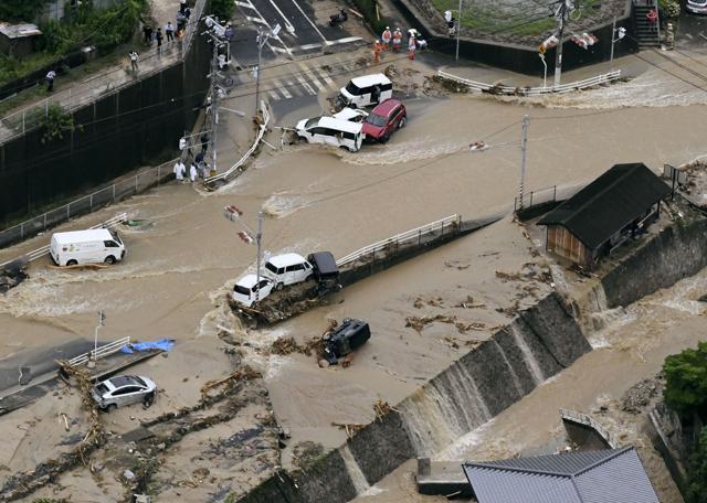 Roads are covered in mud waters after a landslide caused by heavy rains in Aki, Hiroshima prefecture, southwestern Japan on July 7. (AP Photo) Roads are covered in mud waters after a landslide caused by heavy rains in Aki, Hiroshima prefecture, southwestern Japan on July 7. (AP Photo)