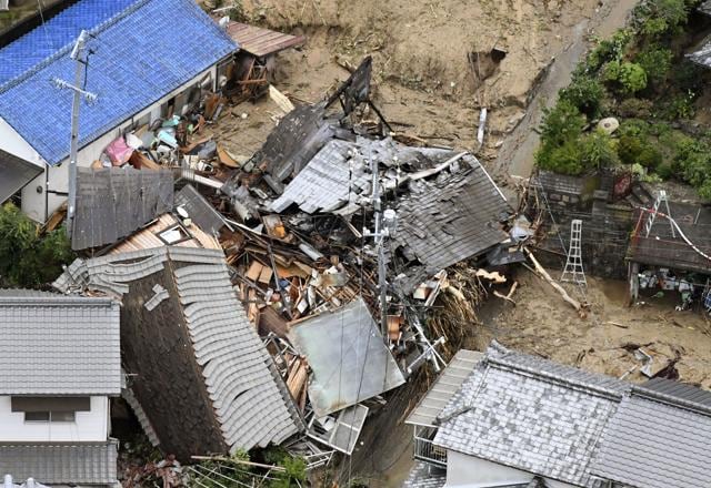 Residential buildings are damaged by a landslide caused by heavy rains in Sakacho, Hiroshima prefecture, south western Japan. (AP) Residential buildings are damaged by a landslide caused by heavy rains in Sakacho, Hiroshima prefecture, south western Japan. (AP)