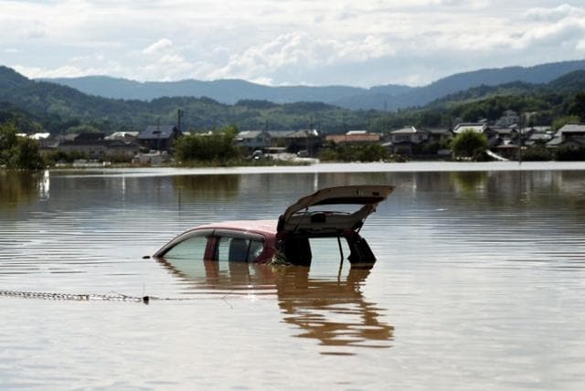 A car is submerged at a flooded area in Mabi town in Kurashiki, Okayama Prefecture. (Reuters)