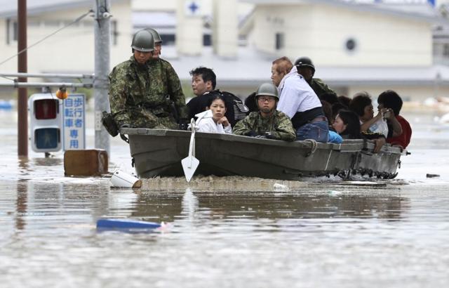 Residents are rescued from a flooded area by Japan self-defence Force soldiers in Kurashiki. (Kyodo/vio Reuters)