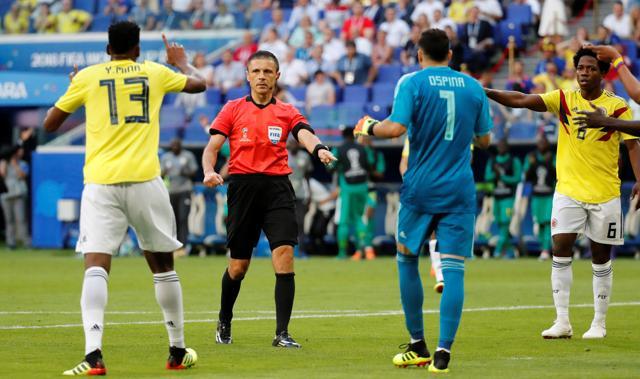 Colombias Yerry Mina reacts as Referee Milorad Mazic awards Senegal a penalty before the decision is reversed following a VAR review. (REUTERS) Colombias Yerry Mina reacts as Referee Milorad Mazic awards Senegal a penalty before the decision is reversed following a VAR review. (REUTERS)