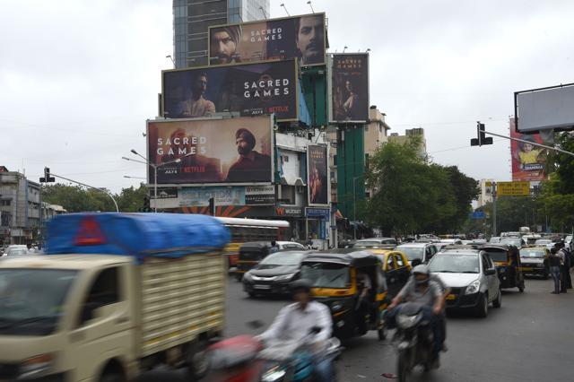 This photo taken on July 4, 2018 shows Indian commuters travelling past large billboards for Sacred Games, the upcoming Indian series on Netflix, in Mumbai. (AFP) This photo taken on July 4, 2018 shows Indian commuters travelling past large billboards for Sacred Games, the upcoming Indian series on Netflix, in Mumbai. (AFP)
