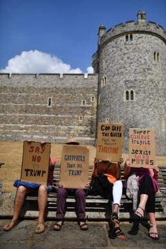 Protesters carry placards outside Windsor Castle in Windsor, west of London, on July 13, 2018. (AFP) Protesters carry placards outside Windsor Castle in Windsor, west of London, on July 13, 2018. (AFP)