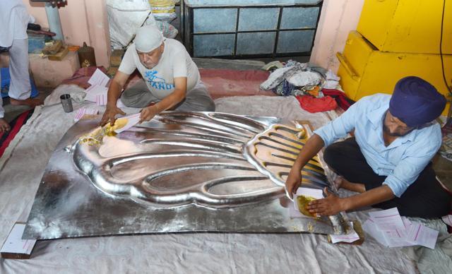 After applying mercury, craftsmen applying foil of gold on copper sheet at Kar Sewa office. (Sameer Sehgal) After applying mercury, craftsmen applying foil of gold on copper sheet at Kar Sewa office. (Sameer Sehgal)