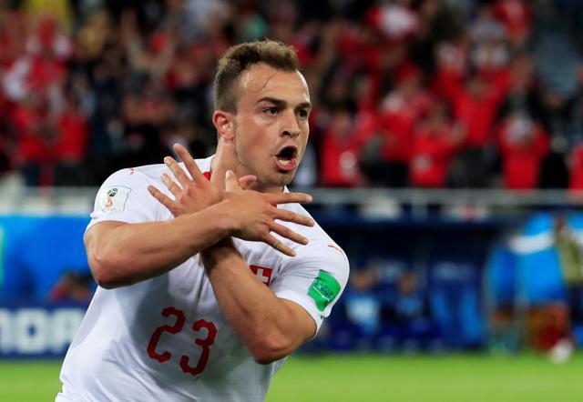 Switzerland's Xherdan Shaqiri celebrates scoring celebrating a goal by making a pro-Kosovan ‘double eagle’ gesture which represents the Albanian flag (REUTERS) Switzerland's Xherdan Shaqiri celebrates scoring celebrating a goal by making a pro-Kosovan ‘double eagle’ gesture which represents the Albanian flag (REUTERS)