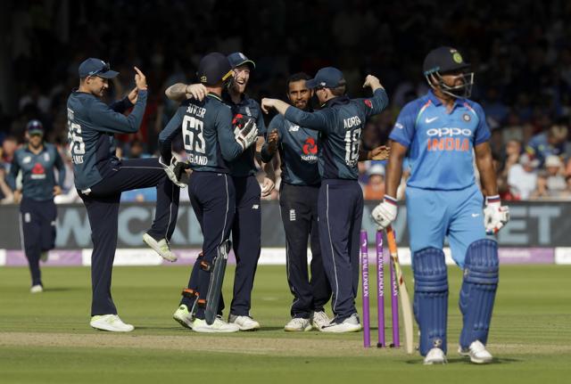 England's Adil Rashid, third right, celebrates taking the wicket of India's Suresh Raina. (AP)