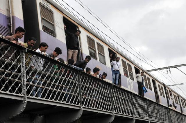 A local train track, which runs just above the river, had onlookers check the rescue operation in action on Saturday. (HT PHOTO)