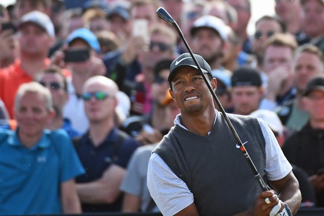 US golfer Tiger Woods watches his iron shot from the 18th tee. (AFP)